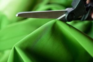 Scissors cutting fabric of cushions