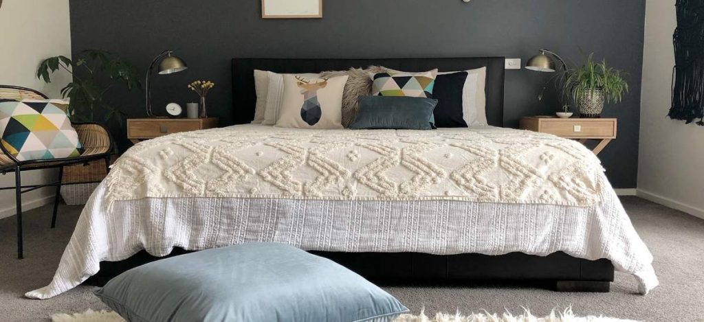 Bedroom with blue and grey cushions and a blue floor cushion