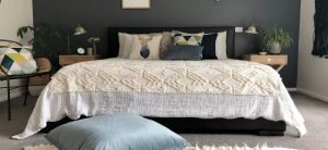 Bedroom with blue and grey cushions and a blue floor cushion