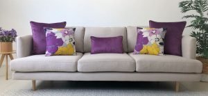 Grey sofa with purple and yellow cushion arrangement