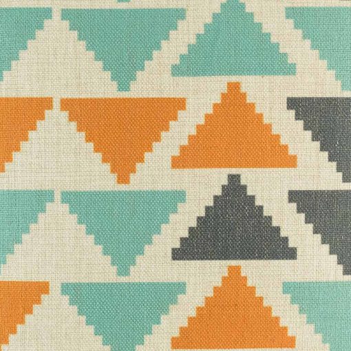 Close up view of orange teal and dark grey triangles on cushion