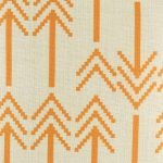 Close in view of orange double arrow heads on cushion cover