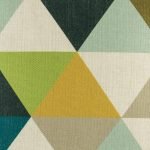 Zoomed in view of triangle pattern on cushion cover in green yellow and teal