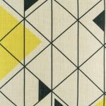 Close up of yellow triangle and black geometric design on cushion cover
