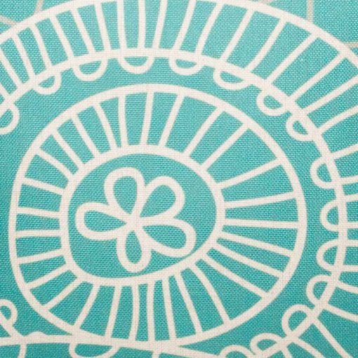 Close up of teal cushion cover with white pattern