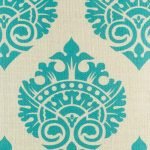 Close view of regal design in teal on linen cushion