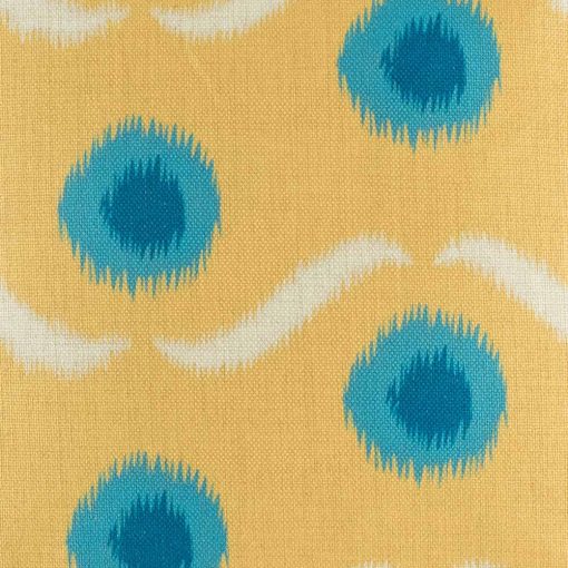 Zoomed in view of yellow cushion with blue polka dots