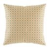 Light coloured cushion with teal polka dot pattern
