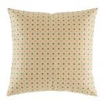 Light coloured cushion with teal polka dot pattern
