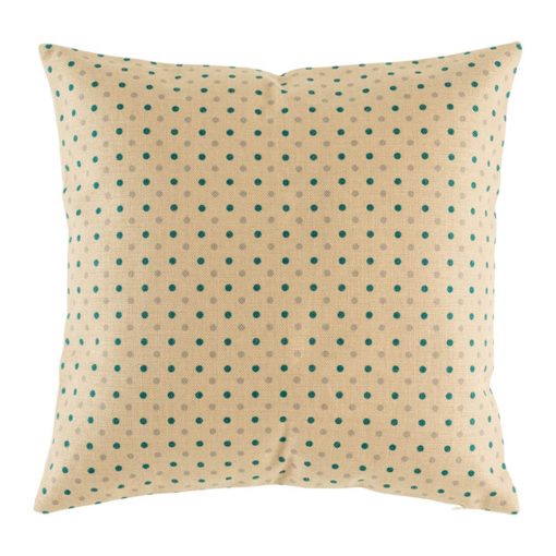 Light coloured cushion with teal polka dot pattern