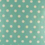 Zoomed in view of teal polka dot pattern on cushion cover