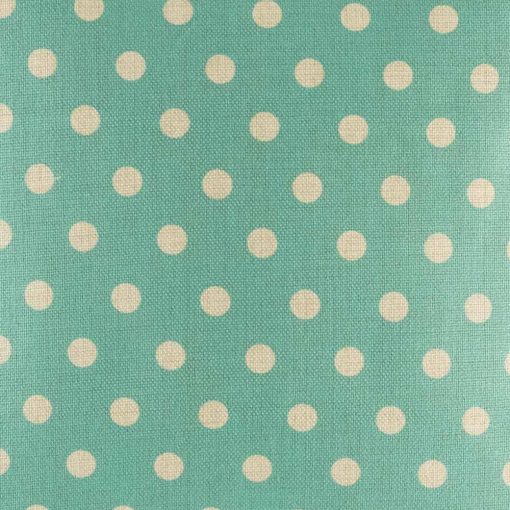 Zoomed in view of teal polka dot pattern on cushion cover