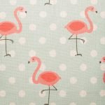 Close up of light blue cushion with flamingo pattern