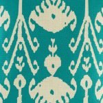 Close up of swirling eye design in teal on cushion cover