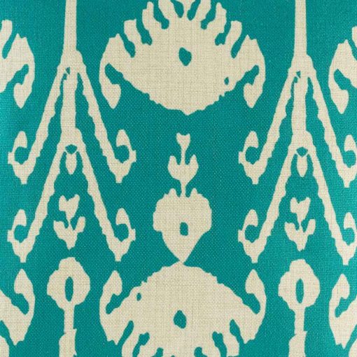 Close up of swirling eye design in teal on cushion cover