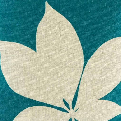 Close up of teal cushion cover with leaf
