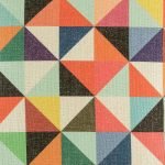 Close up view of colourful cushion cover with triangle pattern