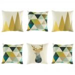 Beautiful 6 cushion collection with 2 brown triangle trees, 3 teal, green and blue geometric diamonds and 1 bold stag head cushion cover