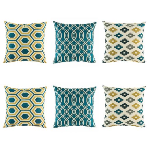 Yellow, blue and grey cushion cover set with striking swirl, repeating pixel and hexagon design