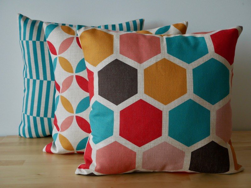 Very colourful cushions stacked in front of one another