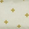 Close up of rectangular linen cushion with gold cross design