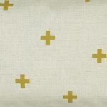 Close up of rectangular linen cushion with gold cross design