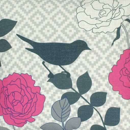 Close up of linen cushion cover with bird and pink flowers