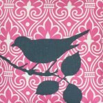 Close up of pink cushion cover with a bird on a branch