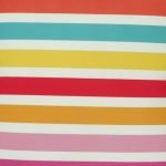 Close-up of velvet cushion cover with multi-colour stripes