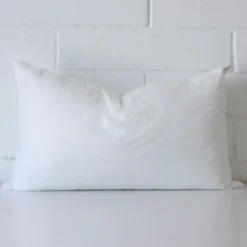 30x50 cushion insert with faux feather microfibre filling positioned against a white wall. The insert is sized at 30 x 50 cm.