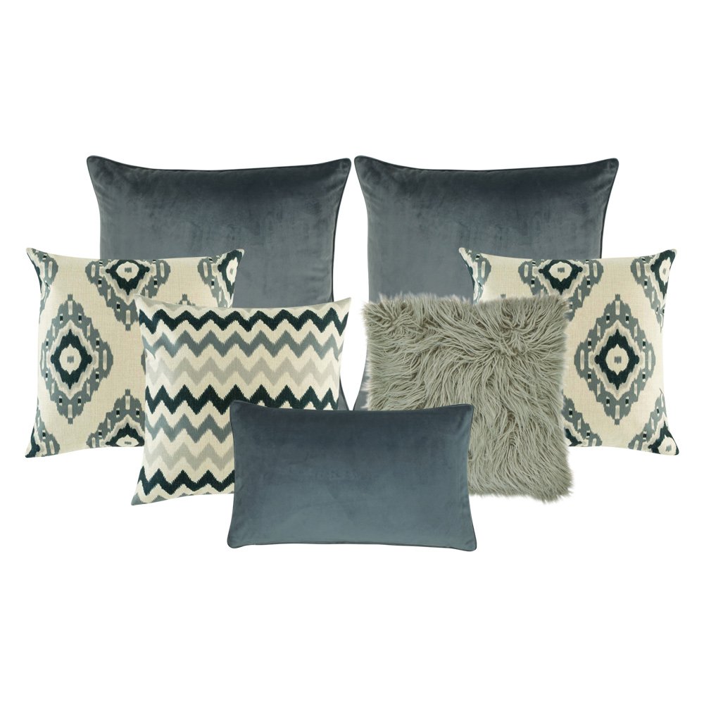 A set of 7 square and rectangular cushions with chevron and diamond patterns and in grey tones