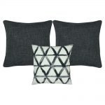 A collection of dark grey and white cushion covers with diamond triangle patterns