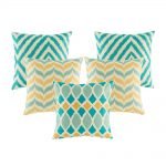 A collection of 5 cushions with teal and gold colours in chevron pattern