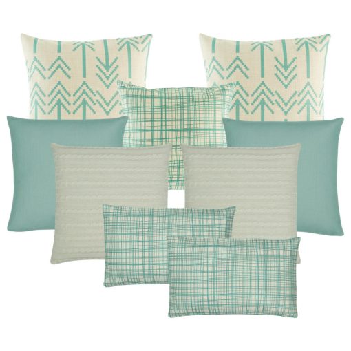A set of 9 cushions with arrow and line patterns in teal and neutral tones
