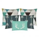 A mix of five cushions in rectangular and square shapes with arrow, moose and triangle designs