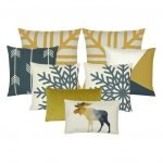 A set of eight gold and blue grey cushion covers in snowflake and moose animal design