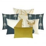 A collection of 6 gold and blue cushion covers in arrow, linear and moose animal prints