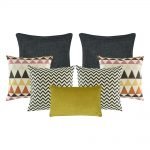 A set of 7 cushion covers with chevron and triangle patterns and in grey and mustard colours