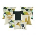 A set of seven cushion covers in gold, green and blue colours with triangle and moose prints