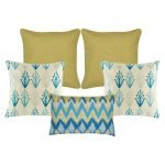 A set of 5 cushions with solid, modern floral and chevron patterns and in gold and blue colours
