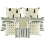 Photo of eight cushion covers with stripes, cross, tree patterns in grey and white colours