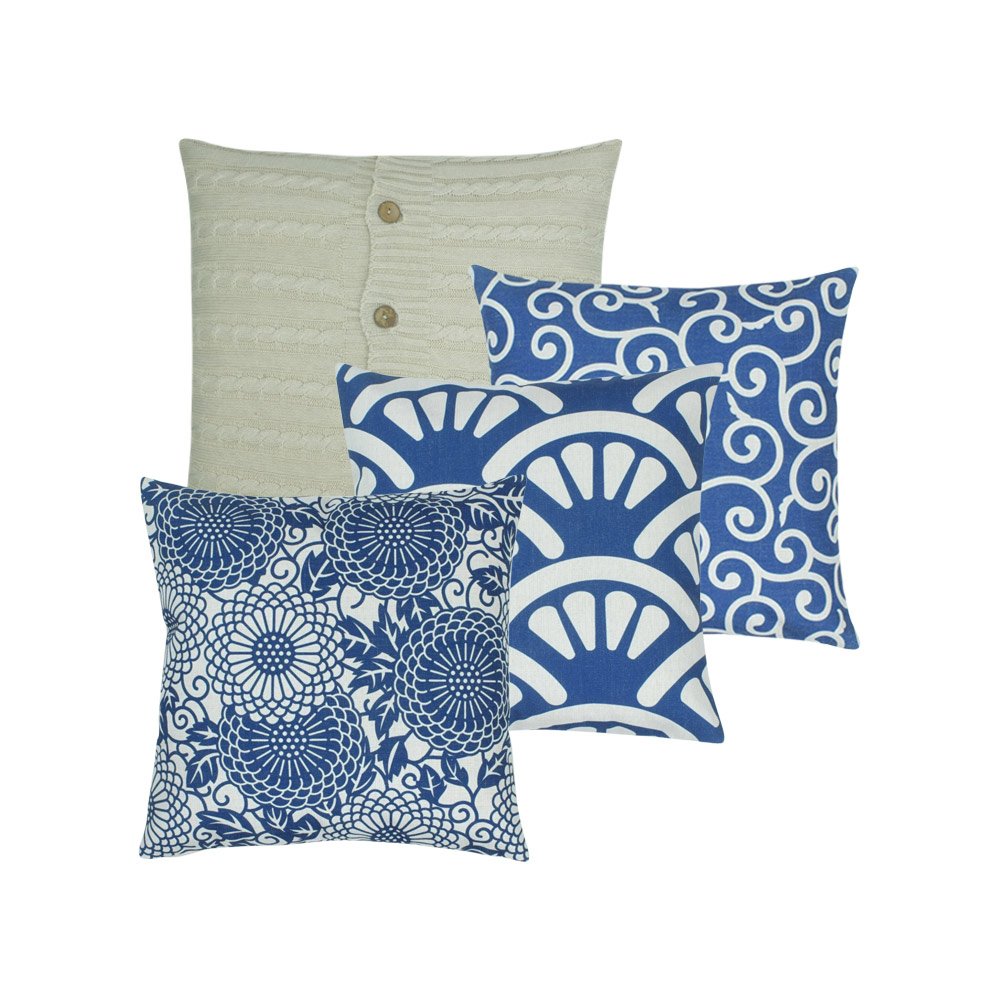 A collection of 4 square blue and white cushions in shell, floral, wind and cable knit patterns