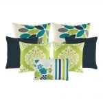 A set of 7 cushion covers in lime and teal colours with floral designs