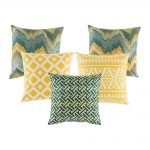 A collection of 5 cushions with blue and gold colours with abstract and diamond patterns