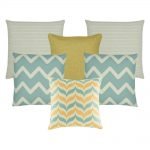 A set of 6 cushions in gold and teal colours with chevron and solid patterns