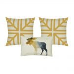 A photo of three cushion covers in gold and white colours