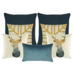 A collection of seven cushion covers in gold, white and blue colours