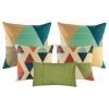 A mix of square and rectangular cushions with diamond and triangle patterns with tones of green blue teal and brown