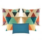 A collection of 5 blue and multi-coloured cushions with diamond and triangle patterns