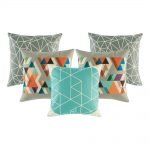 A mix of 5 square teal and grey cushions with triangle patterns